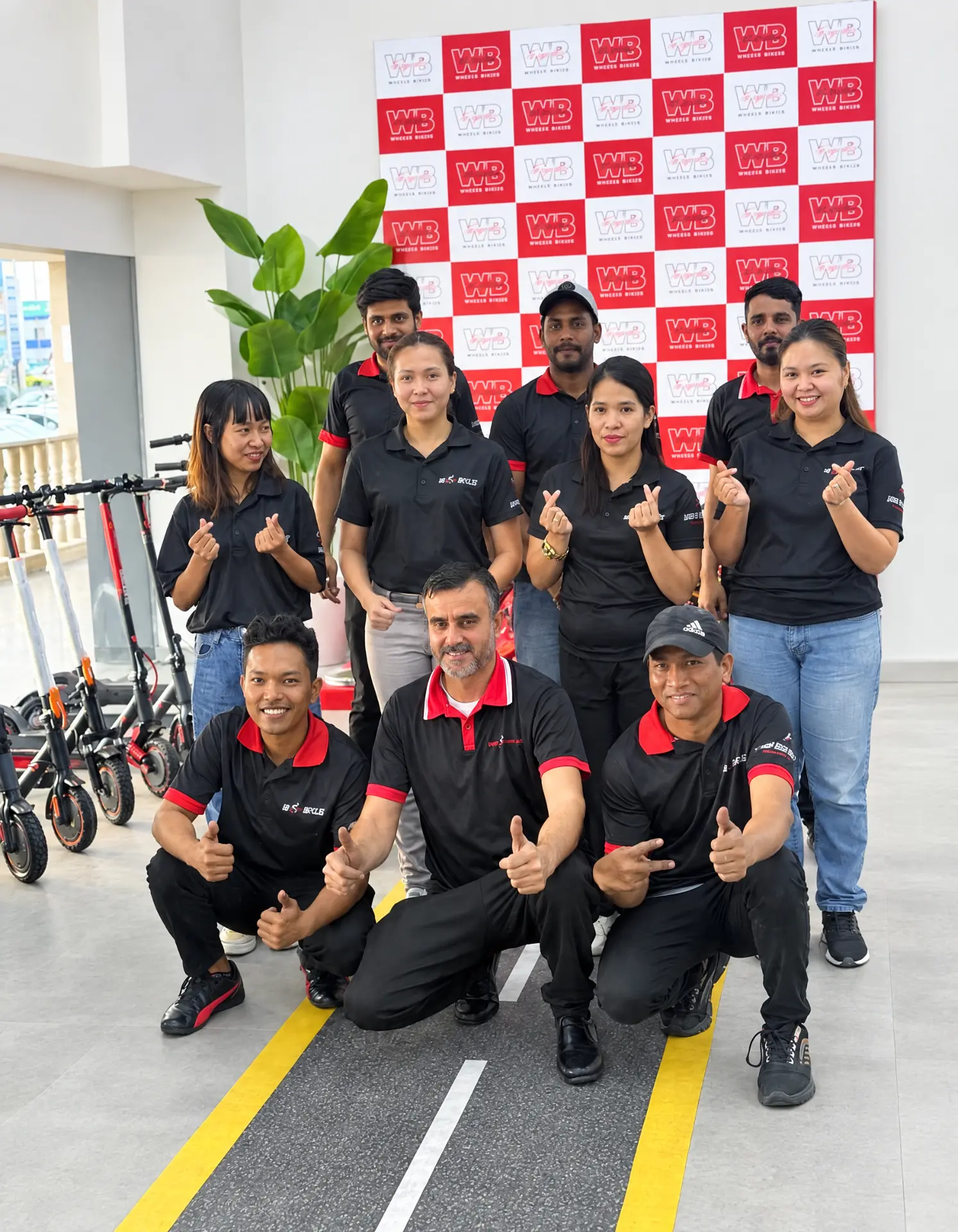 WB Bikes team in front of the WB Bikes backdrop